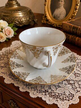 TEA CUP AND SAUCER SET, ENGLAND SUTHERLAND AND DELPHINE VICTORIAN WHIMSICAL